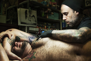 True Blue Tattoo manager and artist Cory Correia works on a tattoo on Jon Shakarisaz’s ribcage -- a notoriously painful area of the body to have tattooed. Shakarisaz says the pain is worth it though because each tattoo reminds him of a time in his life, good or bad.