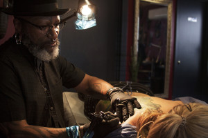 A tattoo “two-years in the making” comes to life on the back of Lauren McIntyre. Austin, TX Zulu Tattoo artist and shop owner fixes McIntyre’s old tattoo by decorating it with the organic, intricate lining characteristic of Art Nouveau.